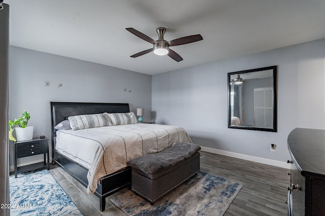 bedroom with ceiling fan, baseboards, and wood finished floors