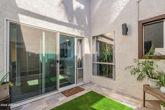 entrance to property featuring stucco siding