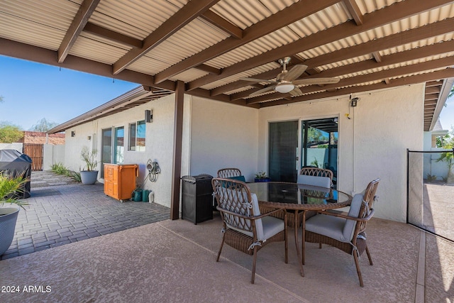 view of patio with a ceiling fan, outdoor dining space, a grill, and fence