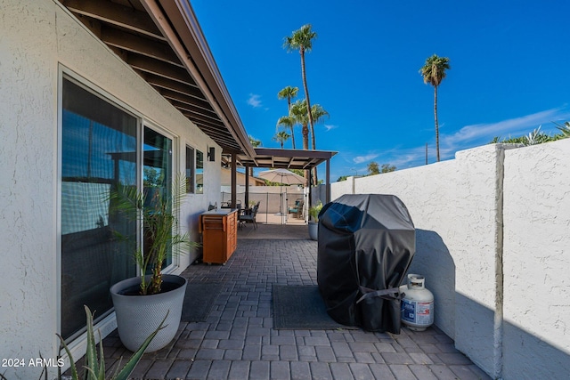 view of patio / terrace featuring a fenced backyard and a grill