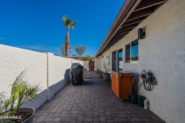 view of patio featuring a fenced backyard and a grill