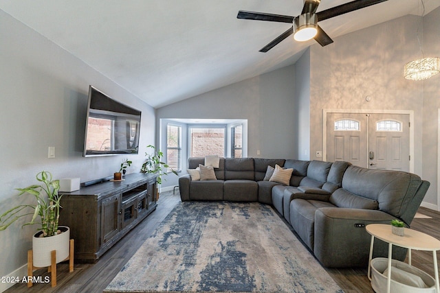 living room featuring high vaulted ceiling, ceiling fan, baseboards, and dark wood finished floors