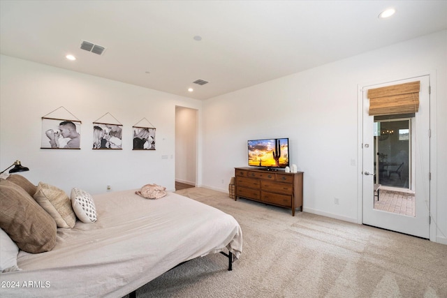 bedroom featuring light colored carpet