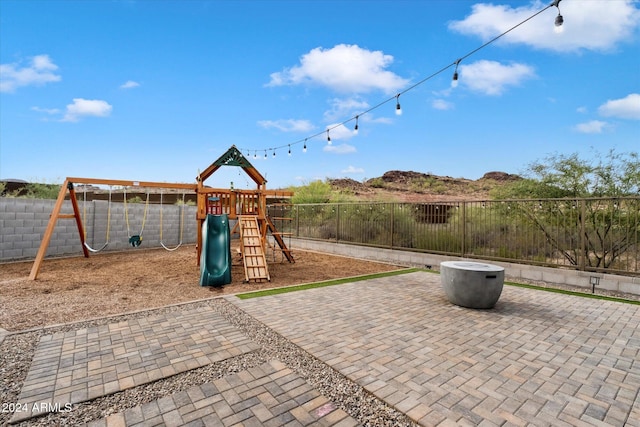 view of jungle gym featuring a patio area