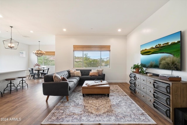 living room featuring wood-type flooring and a chandelier