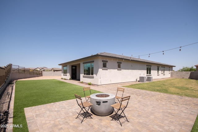 28722 N 133rd Ln, Peoria, AZ 85383 - back of property with stucco siding, a fenced backyard, a patio area, and an outdoor fire pit