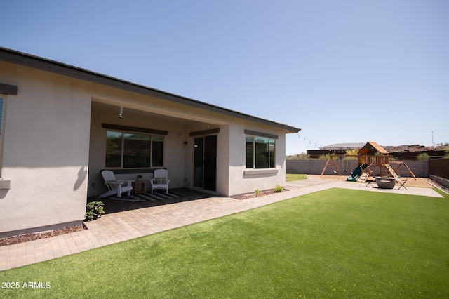 28722 N 133rd Ln, Peoria, AZ 85383 - back of house with a fenced backyard, a playground, and stucco siding