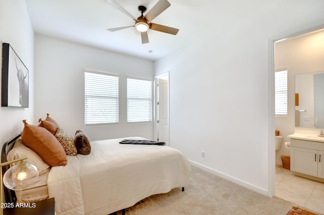 28722 N 133rd Ln, Peoria, AZ 85383 - bedroom featuring a ceiling fan, light colored carpet, a sink, baseboards, and ensuite bathroom
