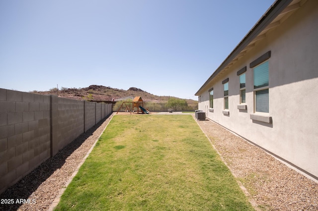 28722 N 133rd Ln, Peoria, AZ 85383 - view of yard featuring a fenced backyard, a playground, and central AC unit