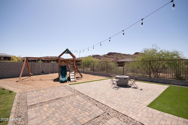 28722 N 133rd Ln, Peoria, AZ 85383 - view of patio with a fenced backyard, a playground, and an outdoor fire pit