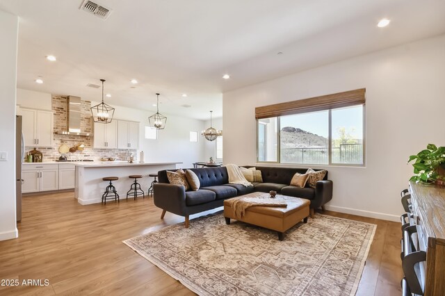28722 N 133rd Ln, Peoria, AZ 85383 - living area featuring a chandelier, recessed lighting, baseboards, light wood-type flooring, and visible vents