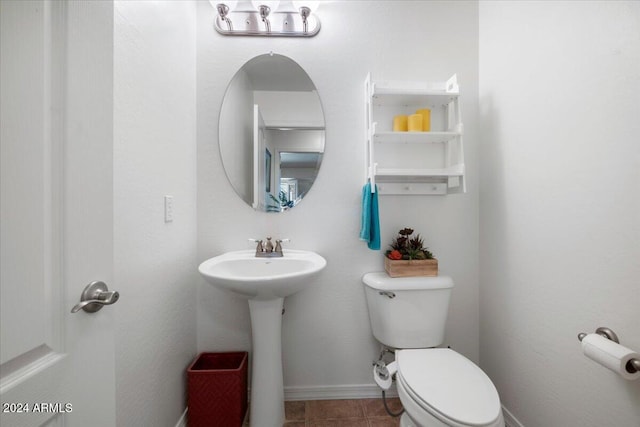 bathroom with tile patterned floors, toilet, and sink