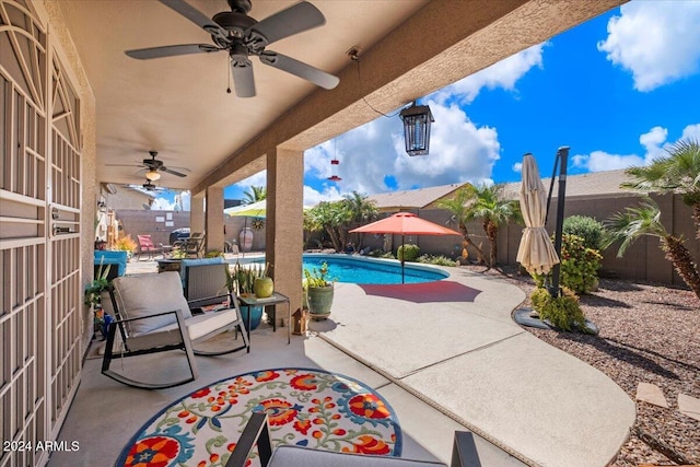 view of patio featuring a fenced in pool and ceiling fan