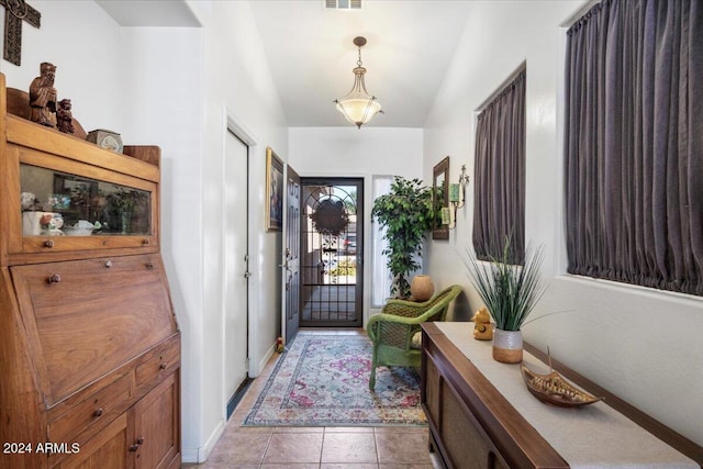 entrance foyer featuring light tile patterned floors and lofted ceiling