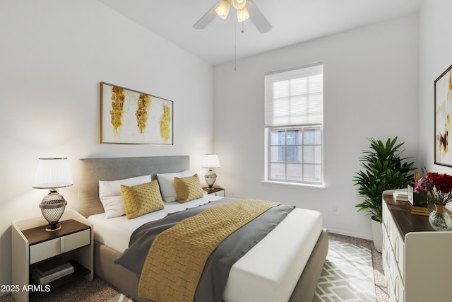 bedroom with light carpet, ceiling fan, and baseboards