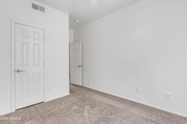 unfurnished bedroom featuring a ceiling fan, baseboards, visible vents, and carpet flooring