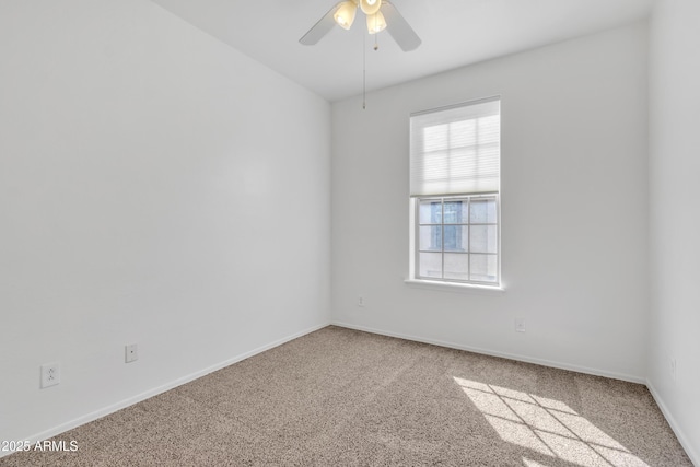 unfurnished room with carpet, baseboards, and a ceiling fan