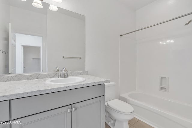 bathroom featuring toilet, bathing tub / shower combination, tile patterned flooring, and vanity