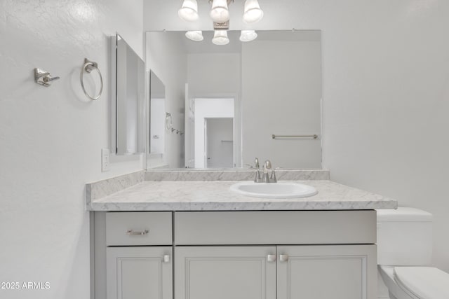 bathroom with toilet and vanity