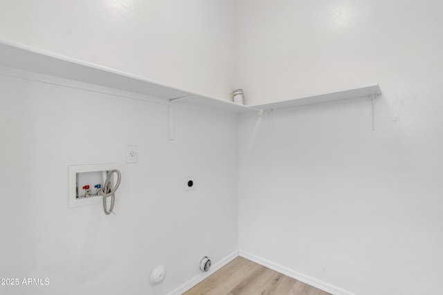 clothes washing area featuring washer hookup, light wood finished floors, electric dryer hookup, laundry area, and baseboards