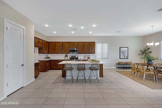 8027 W Northview Ave, Glendale, AZ 85303 - kitchen with stainless steel appliances, light countertops, recessed lighting, light tile patterned flooring, and a kitchen island with sink