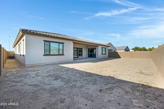 8027 W Northview Ave, Glendale, AZ 85303 - rear view of house with a fenced backyard, stucco siding, a tiled roof, and a patio area