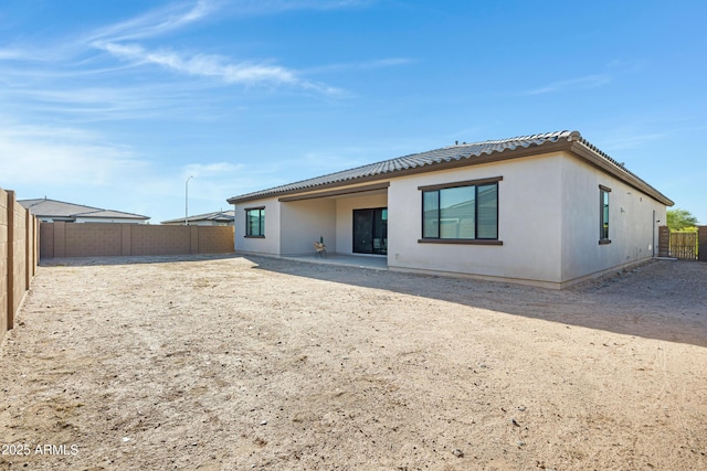 8027 W Northview Ave, Glendale, AZ 85303 - back of property featuring a fenced backyard, stucco siding, a tiled roof, and a patio area