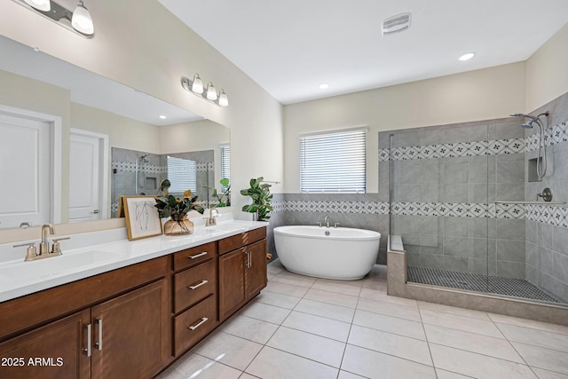 8027 W Northview Ave, Glendale, AZ 85303 - full bath featuring a shower stall, double vanity, tile patterned flooring, a soaking tub, and tile walls