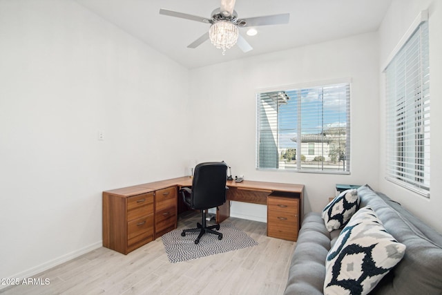 home office with ceiling fan and light hardwood / wood-style flooring