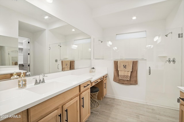 bathroom with vanity, wood-type flooring, and a shower with shower door