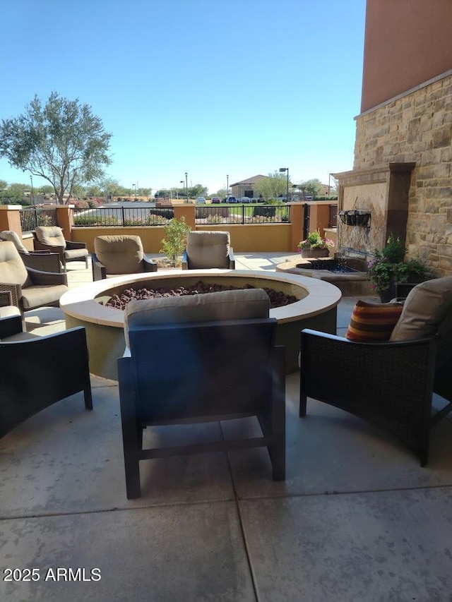 view of patio / terrace with an outdoor living space with a fireplace