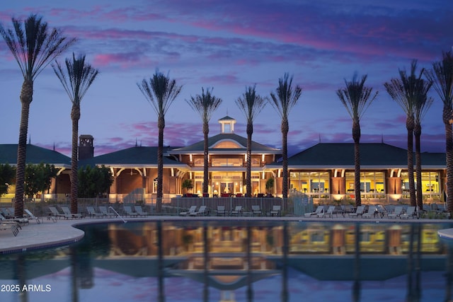 pool at dusk with a patio area