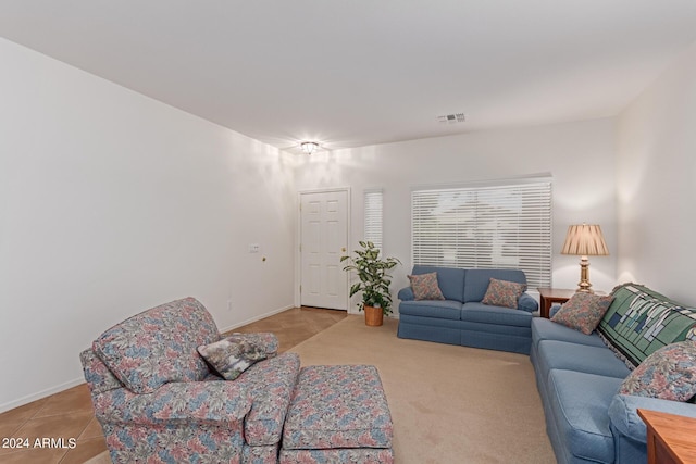 living room with visible vents, baseboards, and light tile patterned flooring