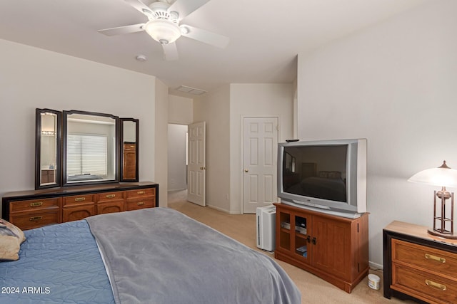 bedroom featuring light carpet and a ceiling fan