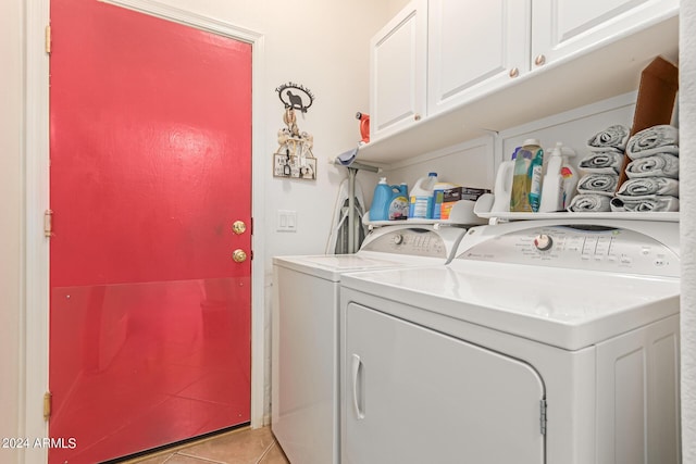 laundry area featuring cabinet space, light tile patterned floors, and separate washer and dryer