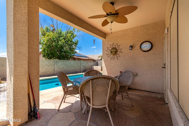 view of patio / terrace featuring ceiling fan, a fenced in pool, and a fenced backyard