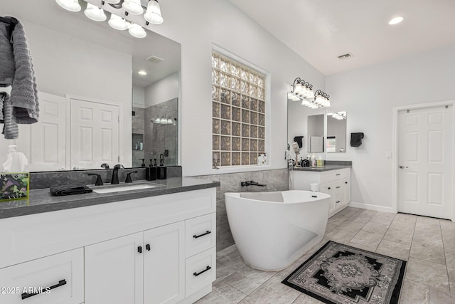 bathroom with tile patterned floors, vanity, and separate shower and tub