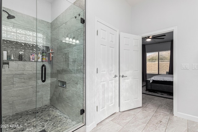 bathroom featuring ceiling fan and an enclosed shower