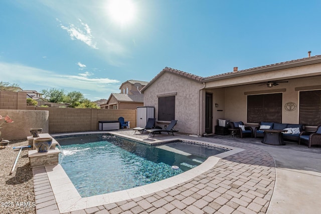 view of swimming pool with pool water feature, ceiling fan, an outdoor living space, and a patio