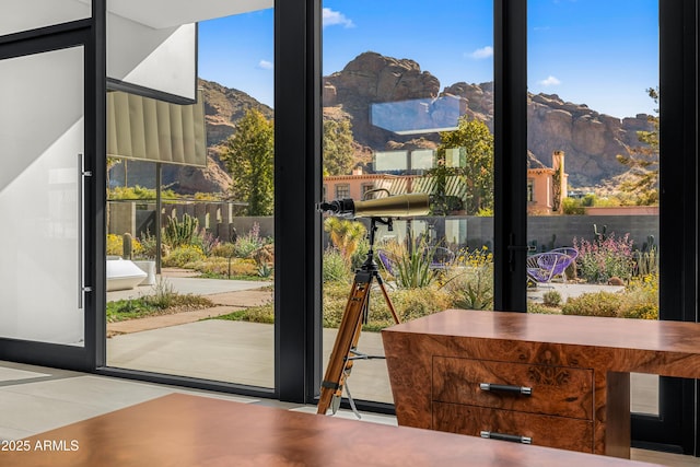 interior space with expansive windows and a mountain view