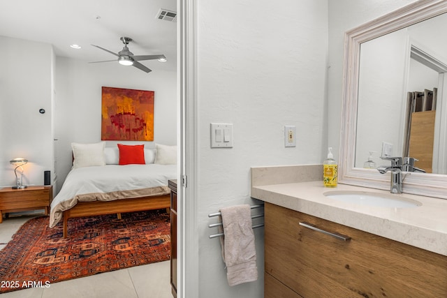 ensuite bathroom with visible vents, a ceiling fan, connected bathroom, vanity, and tile patterned floors