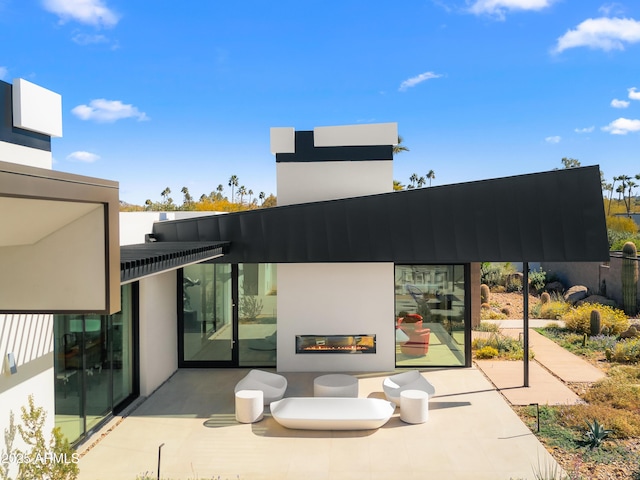 view of patio featuring a glass covered fireplace