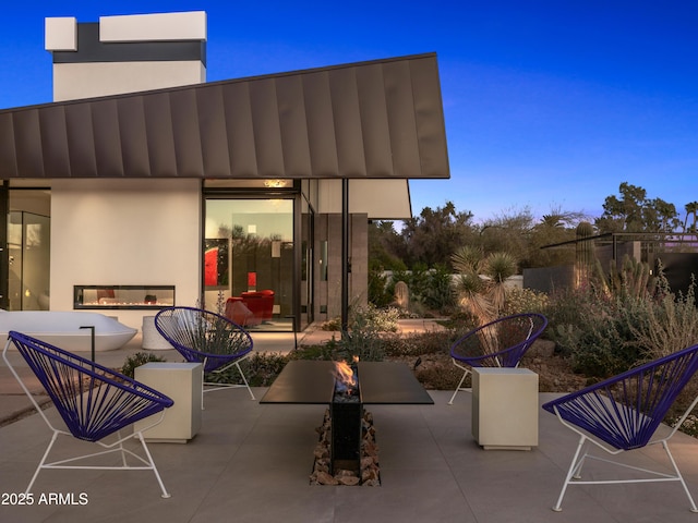 view of patio / terrace with a multi sided fireplace