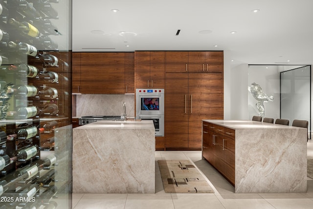 kitchen featuring modern cabinets and a center island with sink