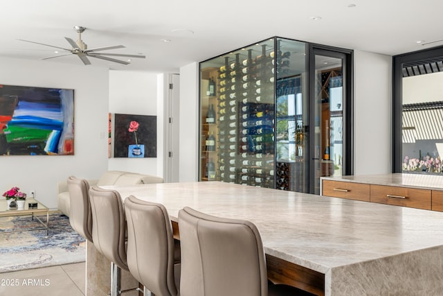 bar with a wall of windows and light tile patterned flooring