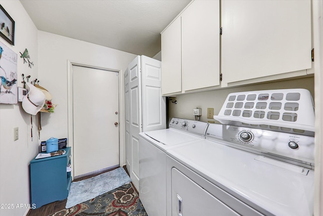 washroom featuring washing machine and clothes dryer and cabinets