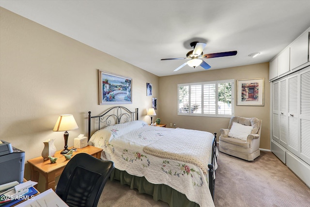 carpeted bedroom featuring ceiling fan and a closet