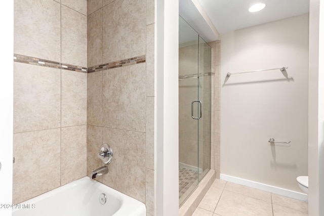 bathroom featuring shower with separate bathtub, toilet, and tile patterned floors