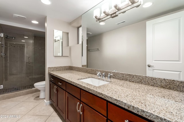 bathroom with tile patterned floors, vanity, toilet, and walk in shower