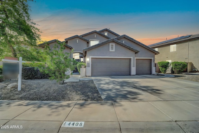 4408 W Summerside Rd, Laveen, AZ 85339 - view of front of property with stucco siding, a garage, driveway, and a tiled roof